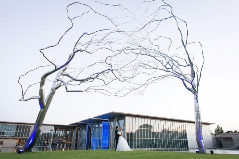 The Modern Art Museum of Fort Worth Lawn with Couple Posed Under Outdoor Art Installation | PartySlate