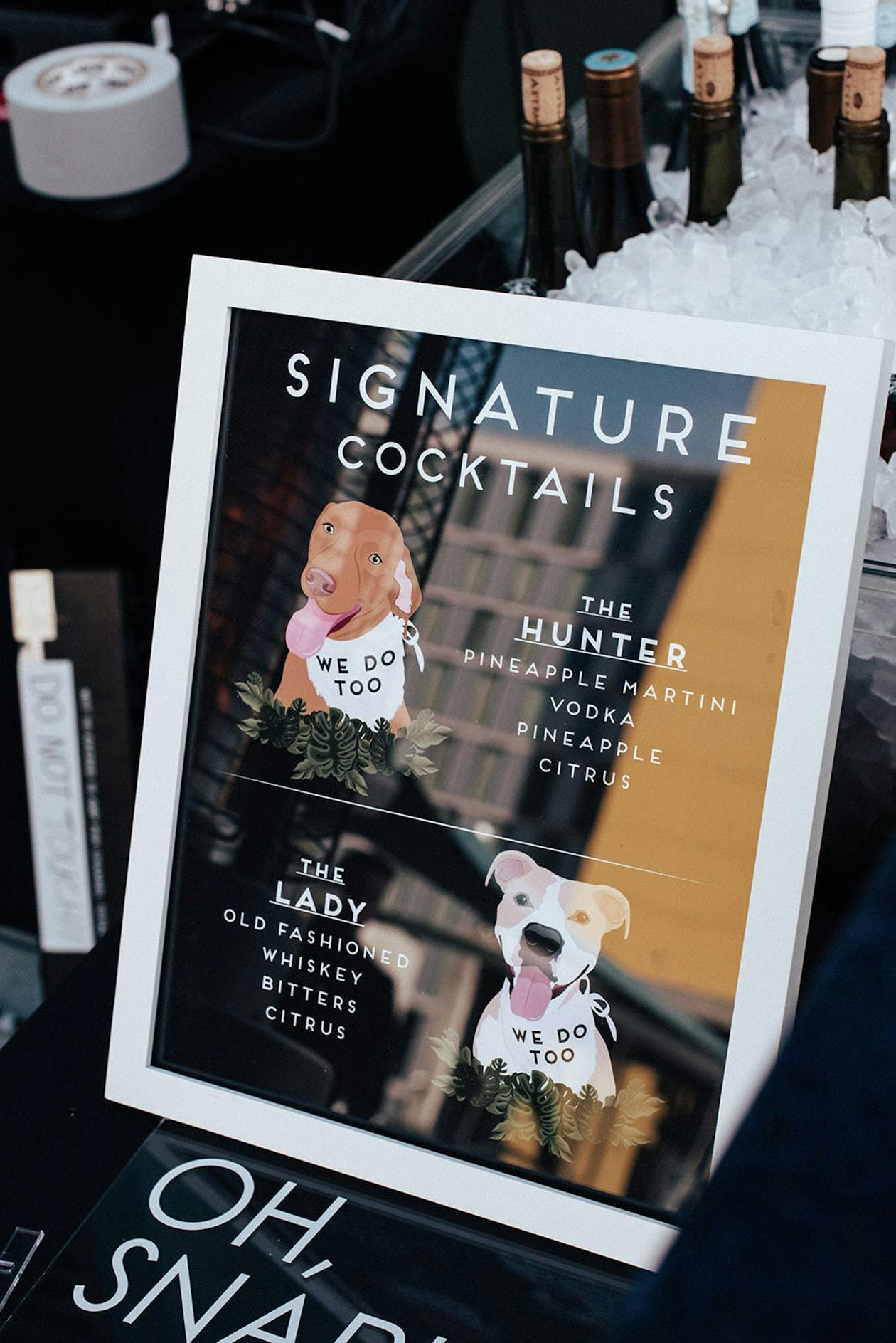 wedding cocktail menu sign with drawings of two dogs | PartySlate