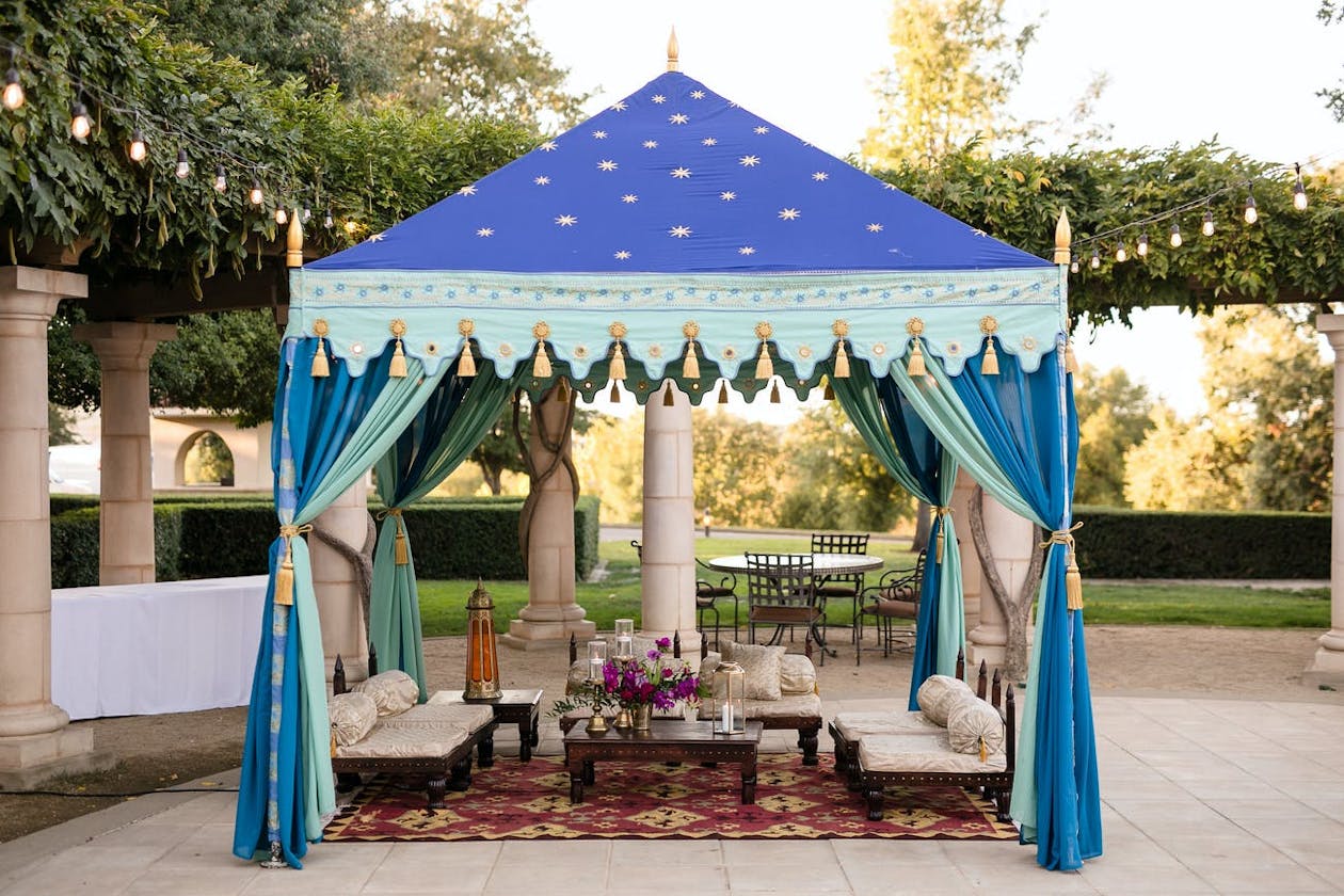 Marquee tent in blue shades stars on canopy for outdoor Sangeet ceremony | PartySlate