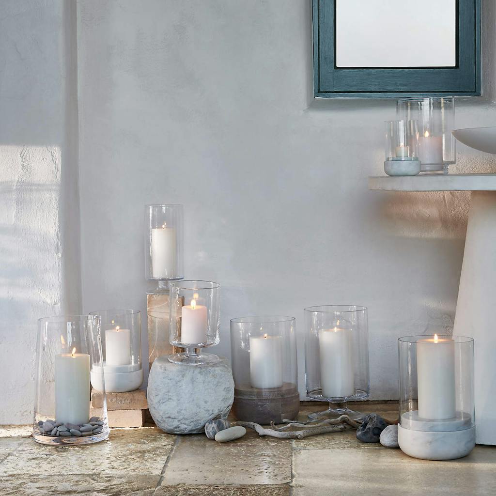 Candles in Clear Glass Vases On The Floor Indoors | PartySlate