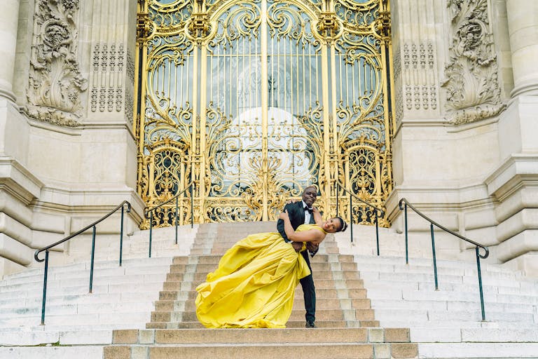 Groom dips bride in yellow ball gown at event planned by PiEvents & Co | PartySlate