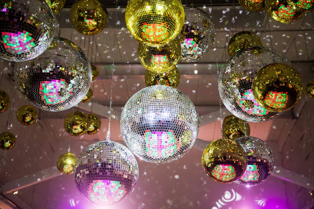 Glittery silver and gold disco balls for a disco theme party | PartySlate