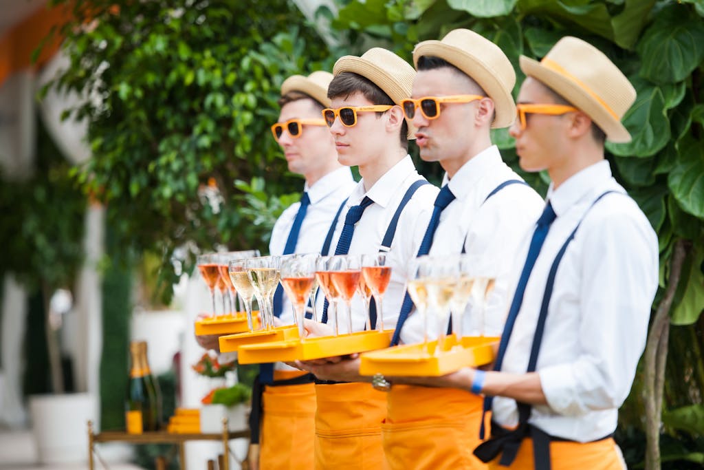 Clicquot summer party with servers in blue and orange | PartySlate
