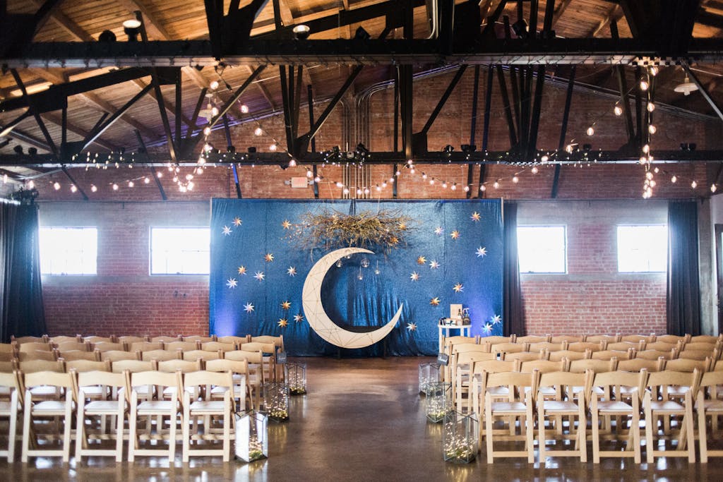 Celestial wedding theme with moon ceremonial backdrop | PartySlate