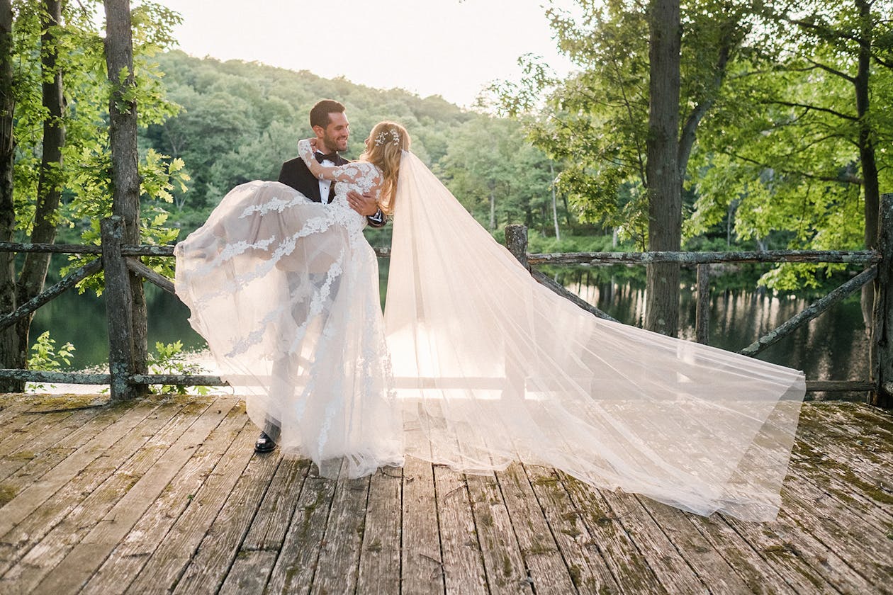 Hudson Valley Wedding Venues Bright Wedding at Cedar Lakes Estate in Port Jervis, NY With Bride and Groom Posing | PartySlate