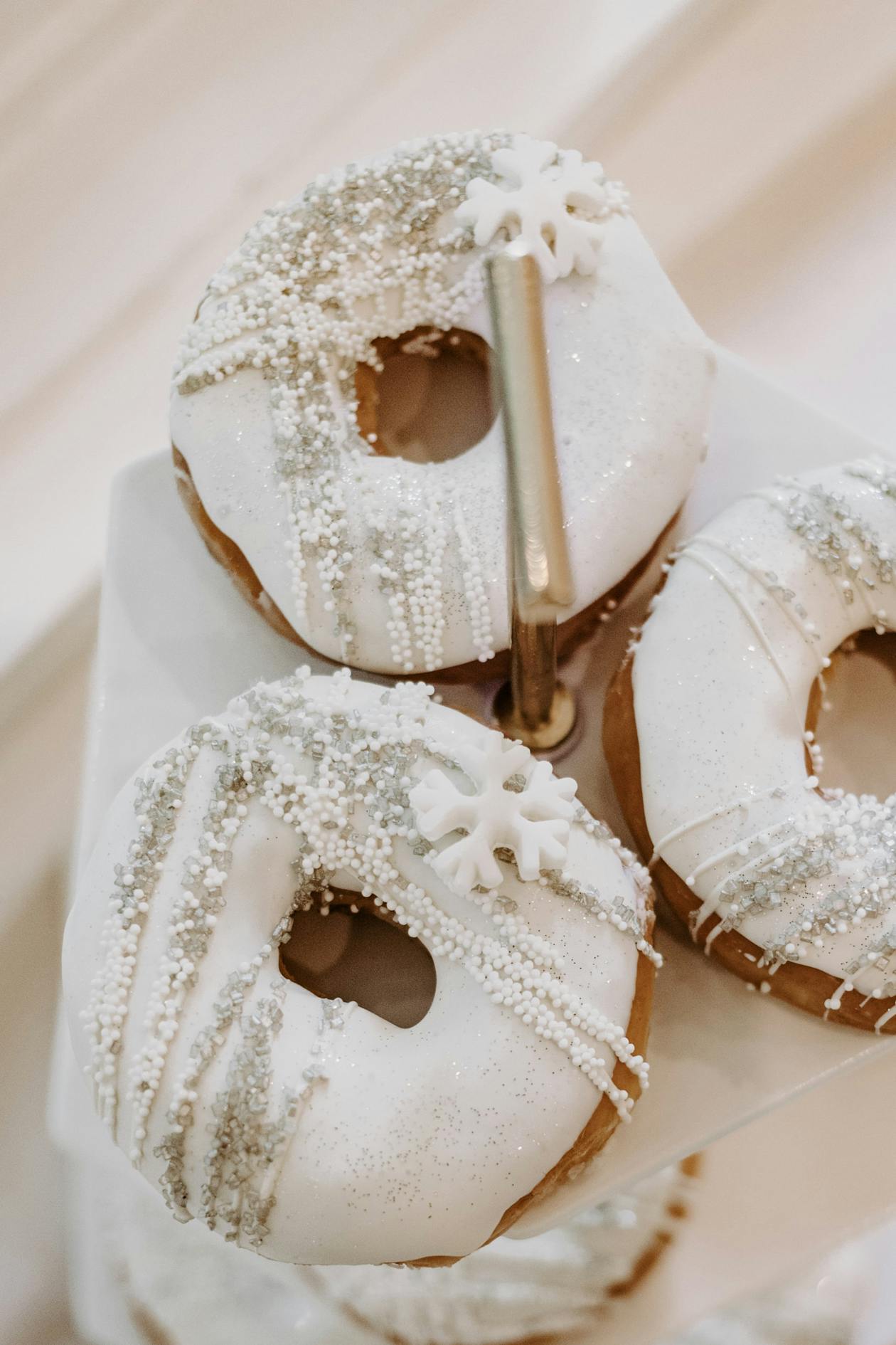 White donuts with snowflake candy and ornament designed cupcakes | PartySlate