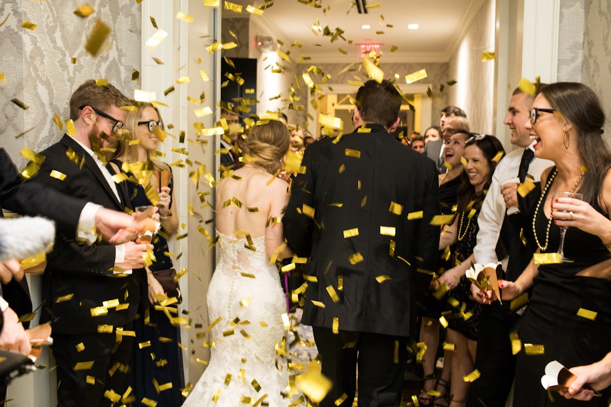 Wedding Exit Idea With Guests Throwing Confetti In Air As Couple Walks Out | PartySlate