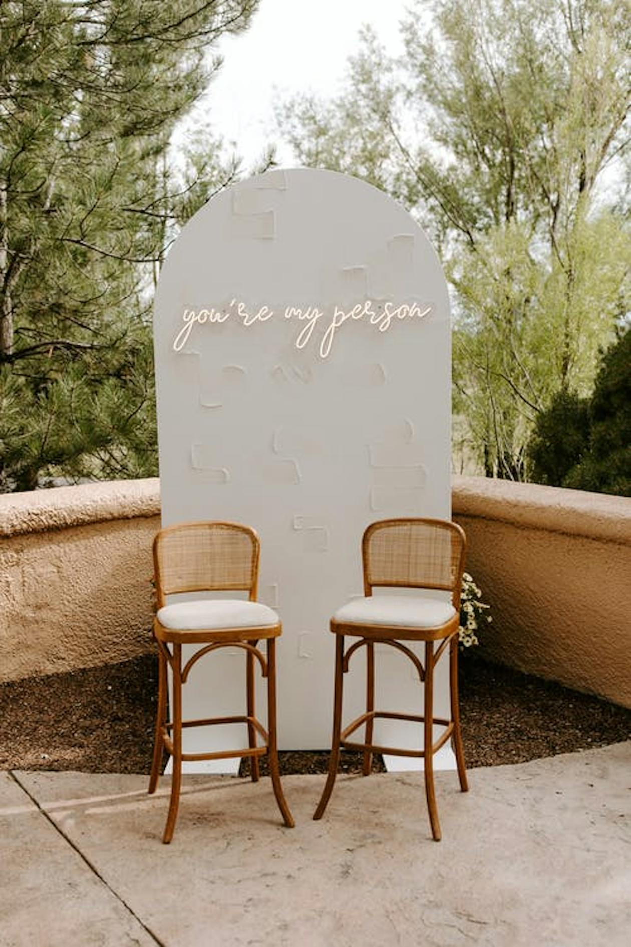 Wedding Backdrop with Sign and Two Chairs Outdoors | PartySlate