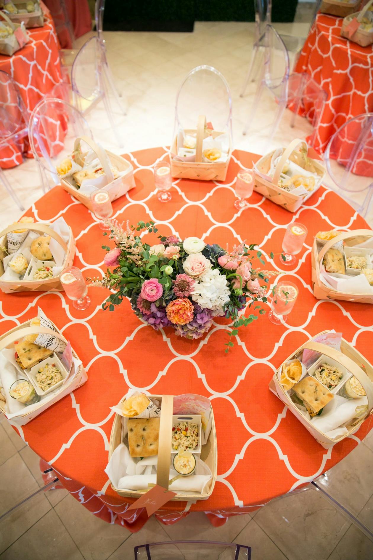 Painting Party With Vibrant Colors and Orange Table Cloth with Picnic Baskets On Top | PartySlate