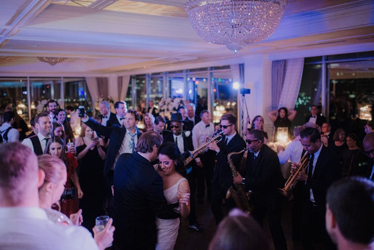 Couple Dancing In Crowd of Guests At Wedding Reception in Houston | PartySlate
