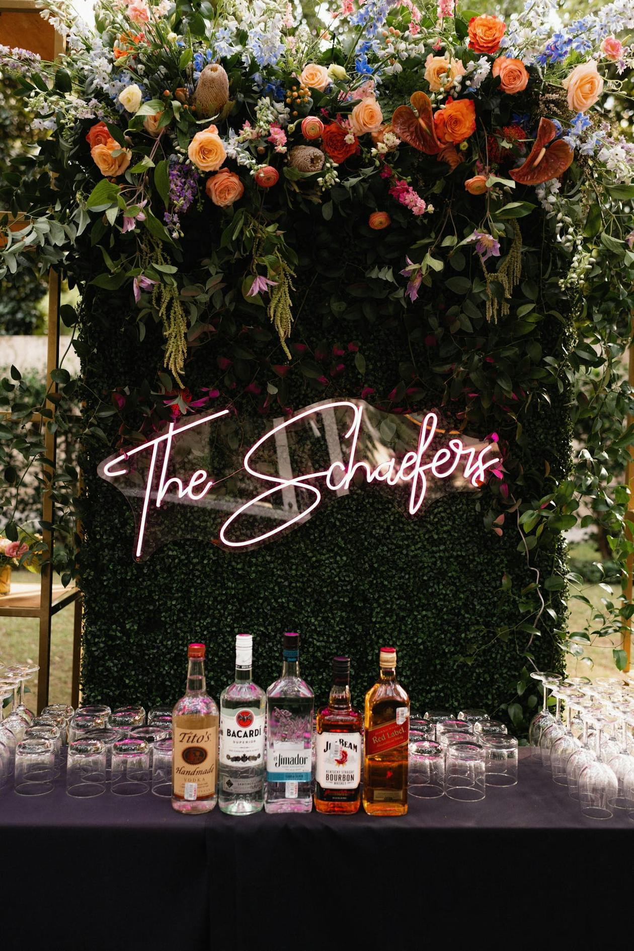 Wedding Bar with Neon Sign and Cocktail glasses with Beverages | PartySlate