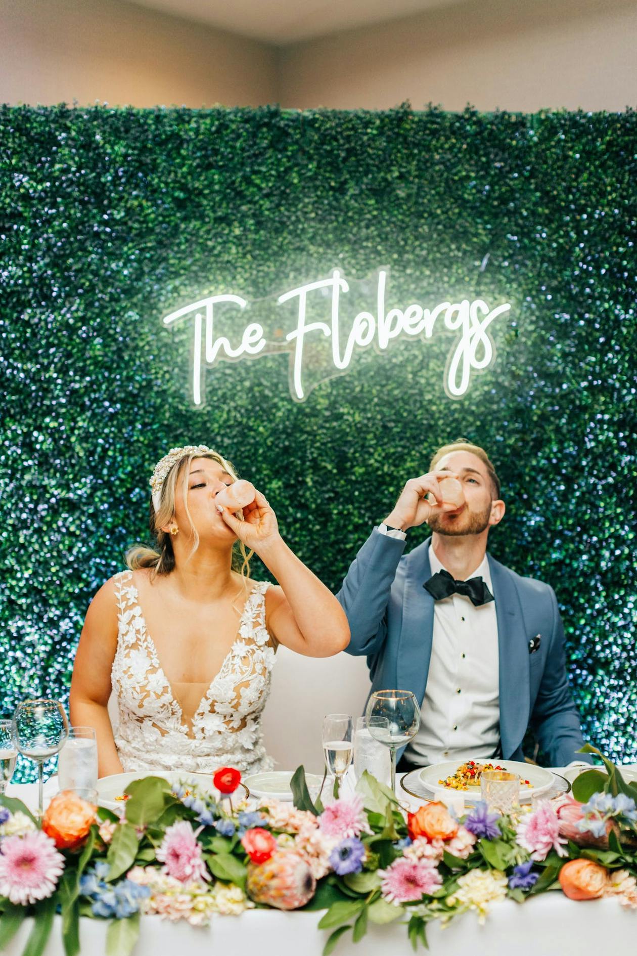 Last Name Wedding Sign Behind Couple | PartySlate
