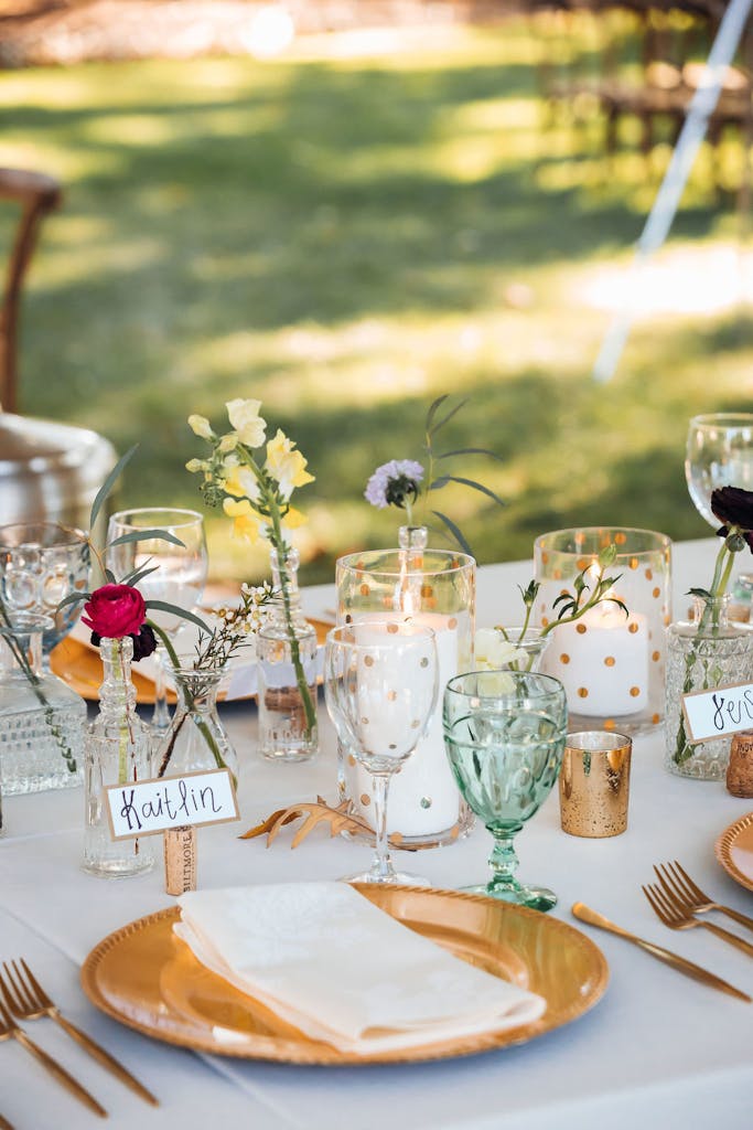 Green Glassware and Gold Plates on Outdoor Wedding Table | PartySlate