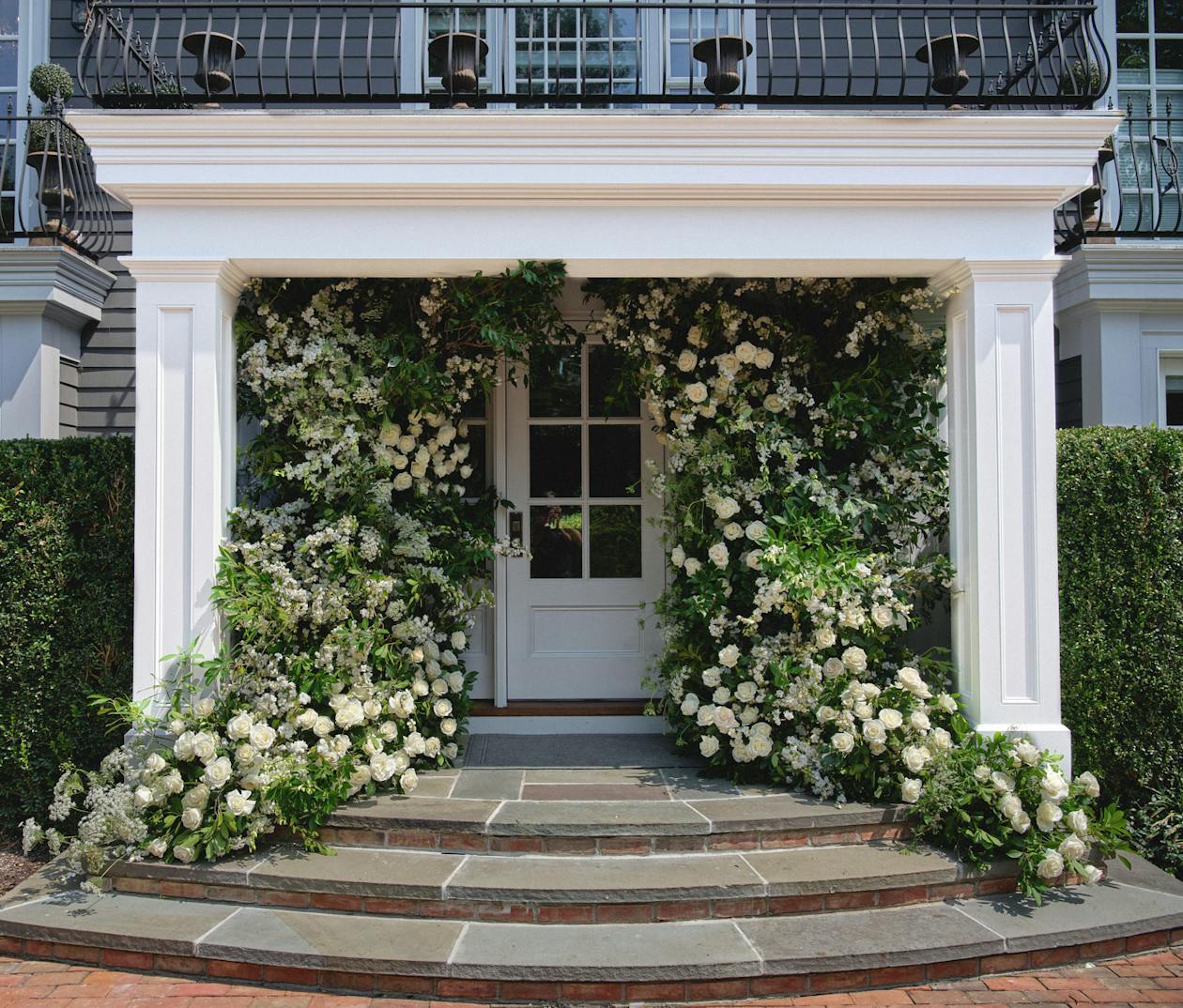 Intimate Wedding Celebration in the Hamptons With Florals and Greenery Surrounding Private Residence Front Door Entrance | PartySlate