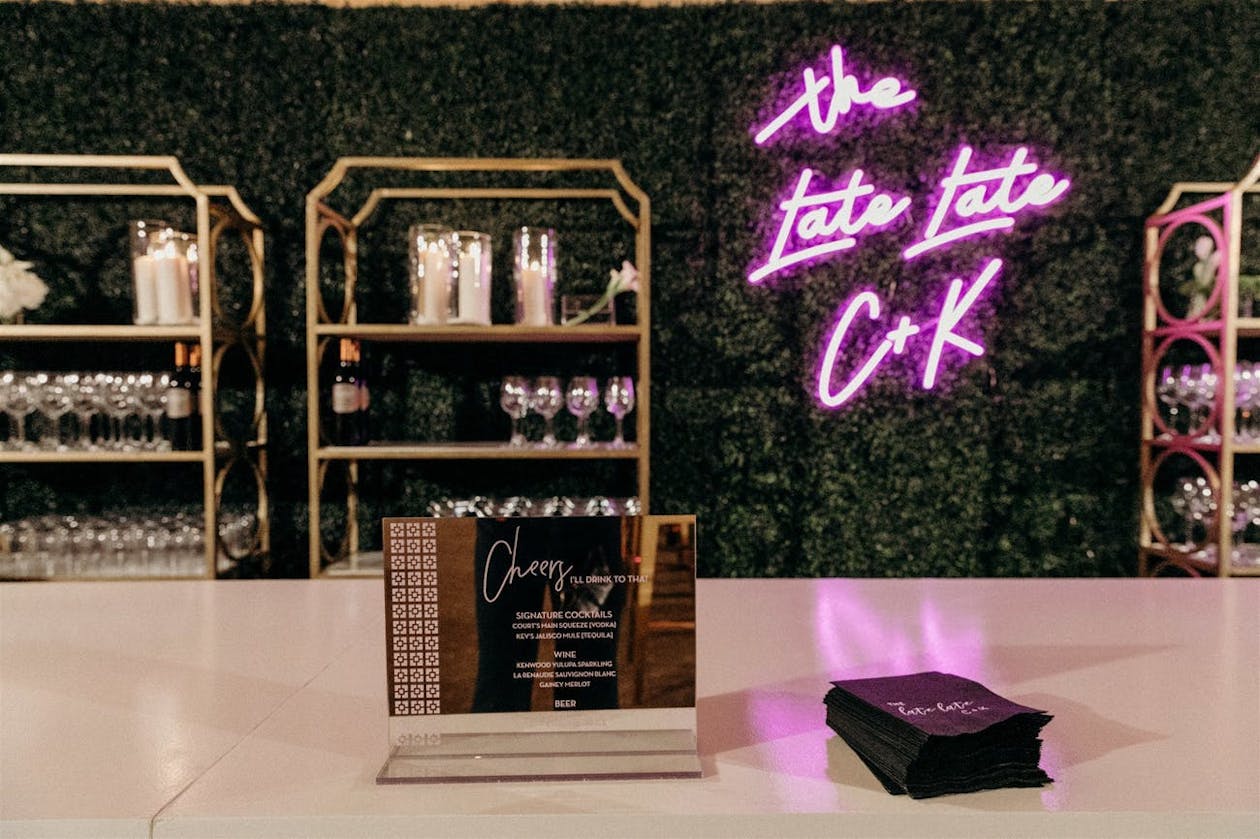 Wedding bar with Pink Custom Neon Sign and Custom Cocktail Napkins | PartySlate
