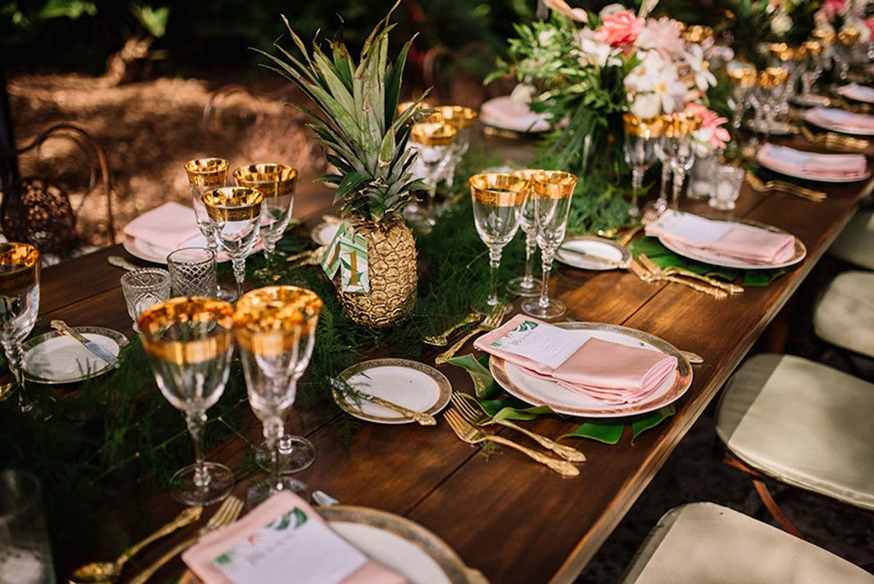 Wedding reception table with gold pineapple wedding centerpieces | PartySlate