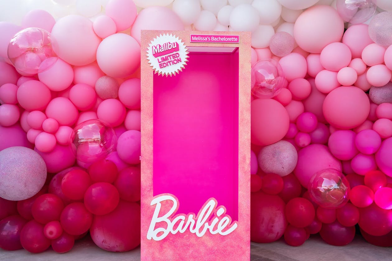 Barbie Themed Pink Party With Hot Pink Decor and Balloons Surrounding Barbie Box Photo Booth | PartySlate