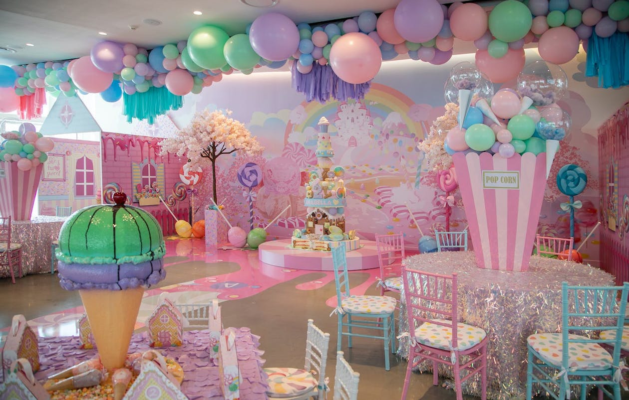 Candy Land Theme Party Decorations with pastel colors and ice cream and popcorn centerpieces | PartySlate