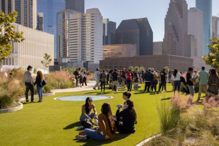POST Houston Skylawn With City in the Background and People Sitting On Grass | PartySlate