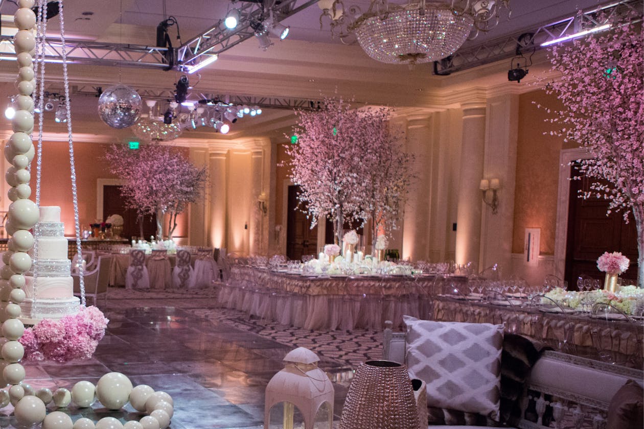 Elegant Pink Wedding With Pink and White Floral and Tree Centerpieces on Table | PartySlate