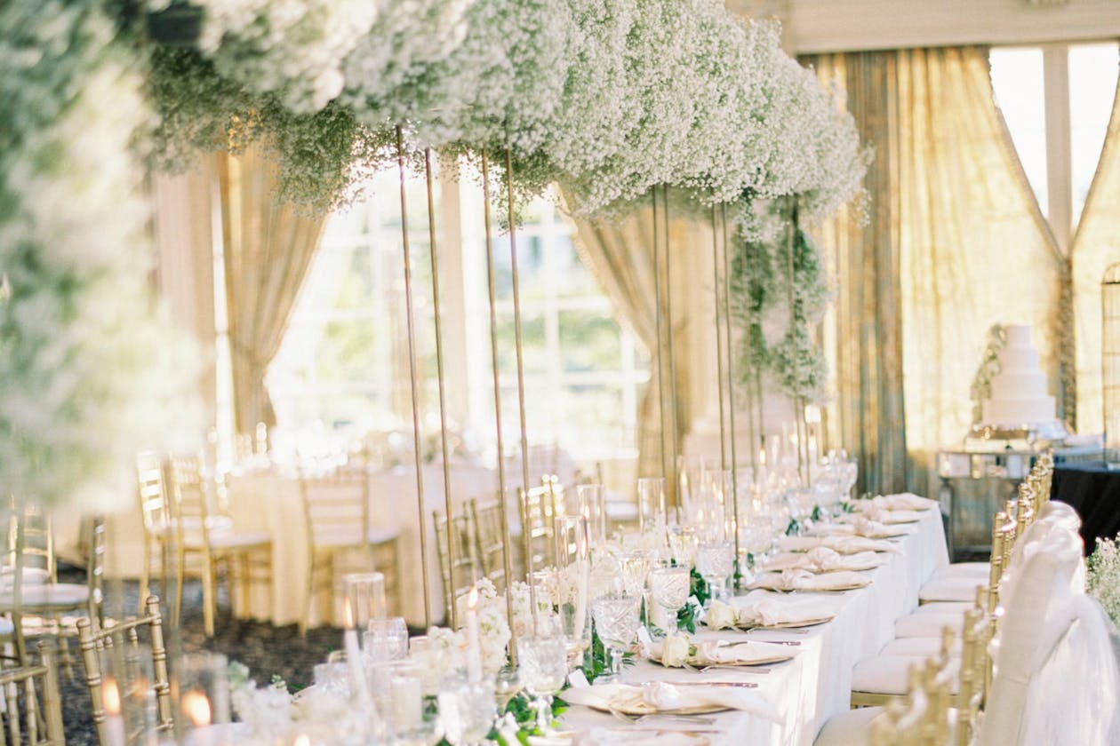 White and Green Tall Spring Wedding Centerpiece With Baby's Breath | PartySlate