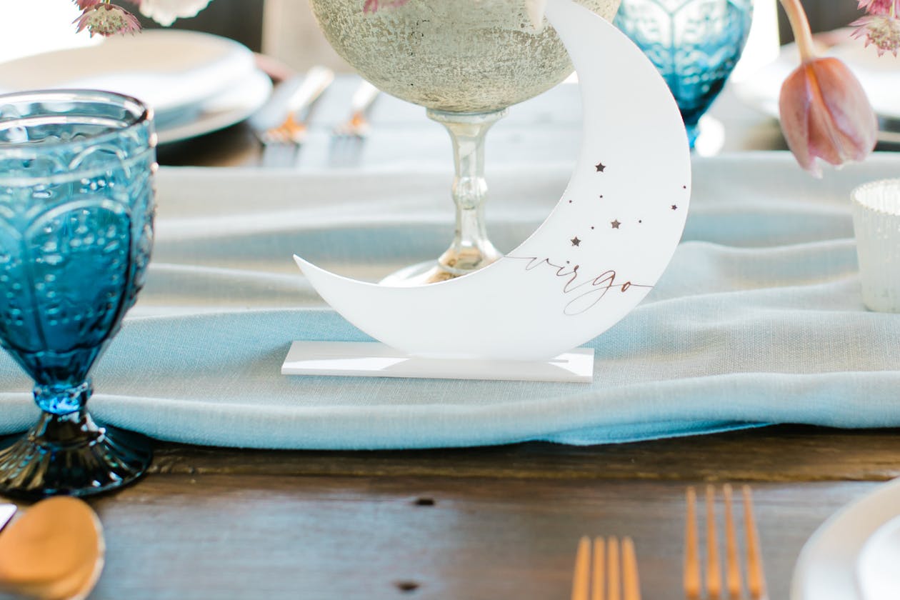 celestial themed wedding with astrological moon and stars place settings on tables | PartySlate