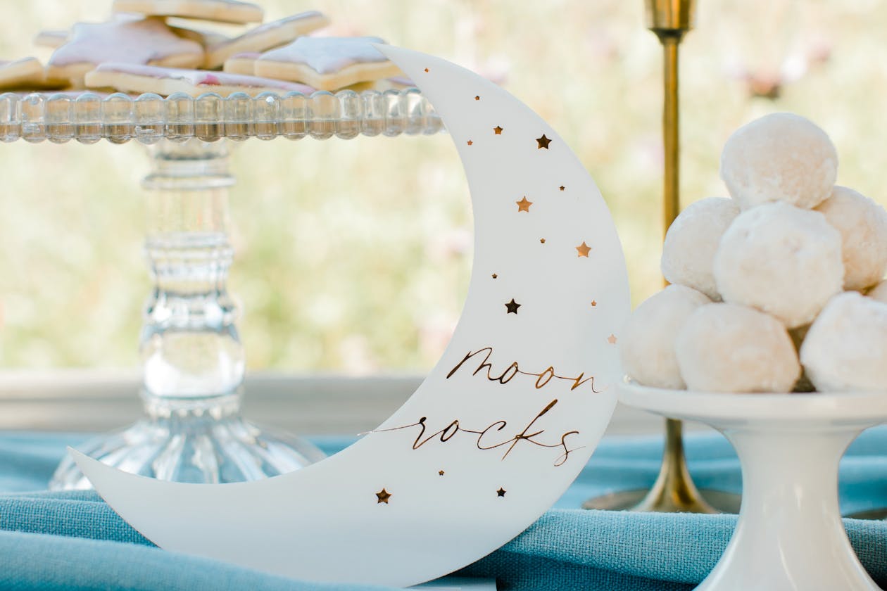 celestial themed food and drink table with cookies and desserts and moon décor | PartySlate