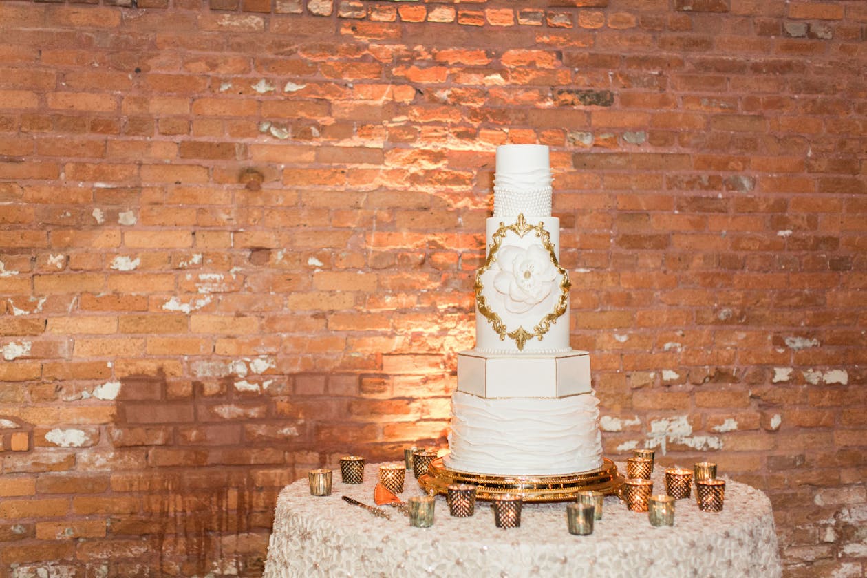 White wedding cake with gold icing | PartySlate