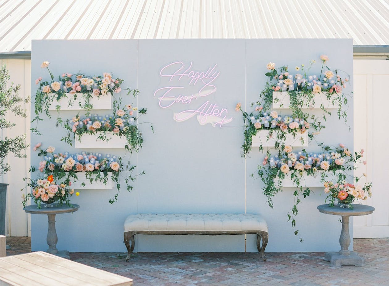 Pastel blue backdrop with flower beds | PartySlate