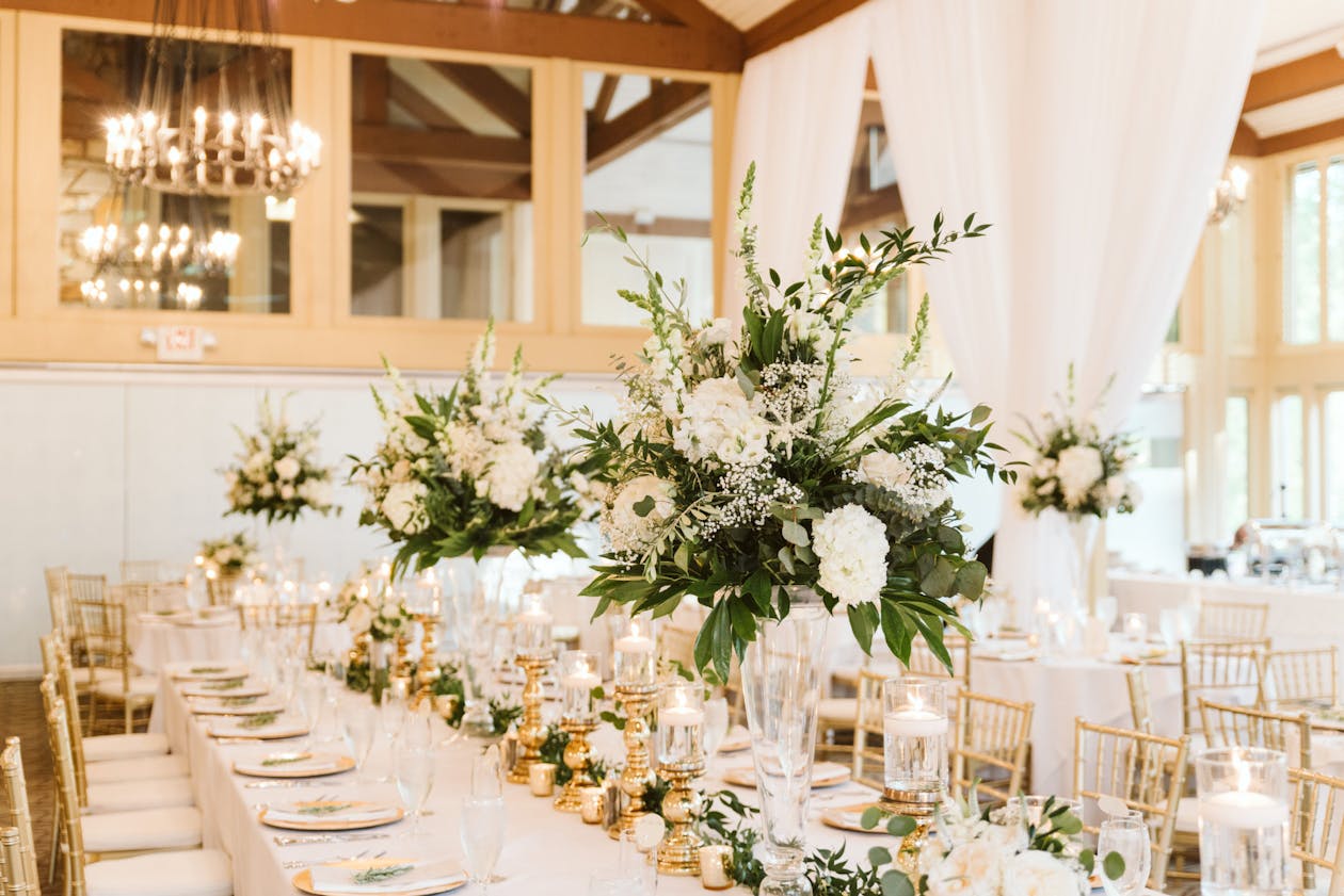 Stunning Spring Wedding centerpiece With Greenery and White Roses | PartySlate