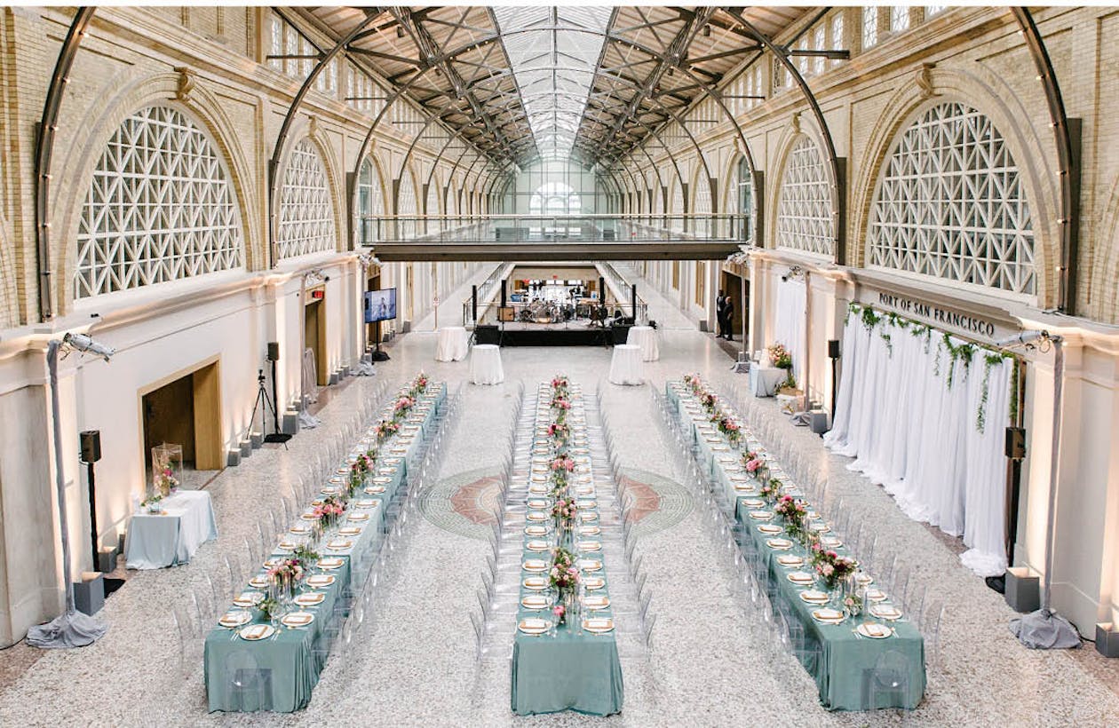 Ferry Building in San Francisco with blue linen on tables and centerpieces | PartySlate