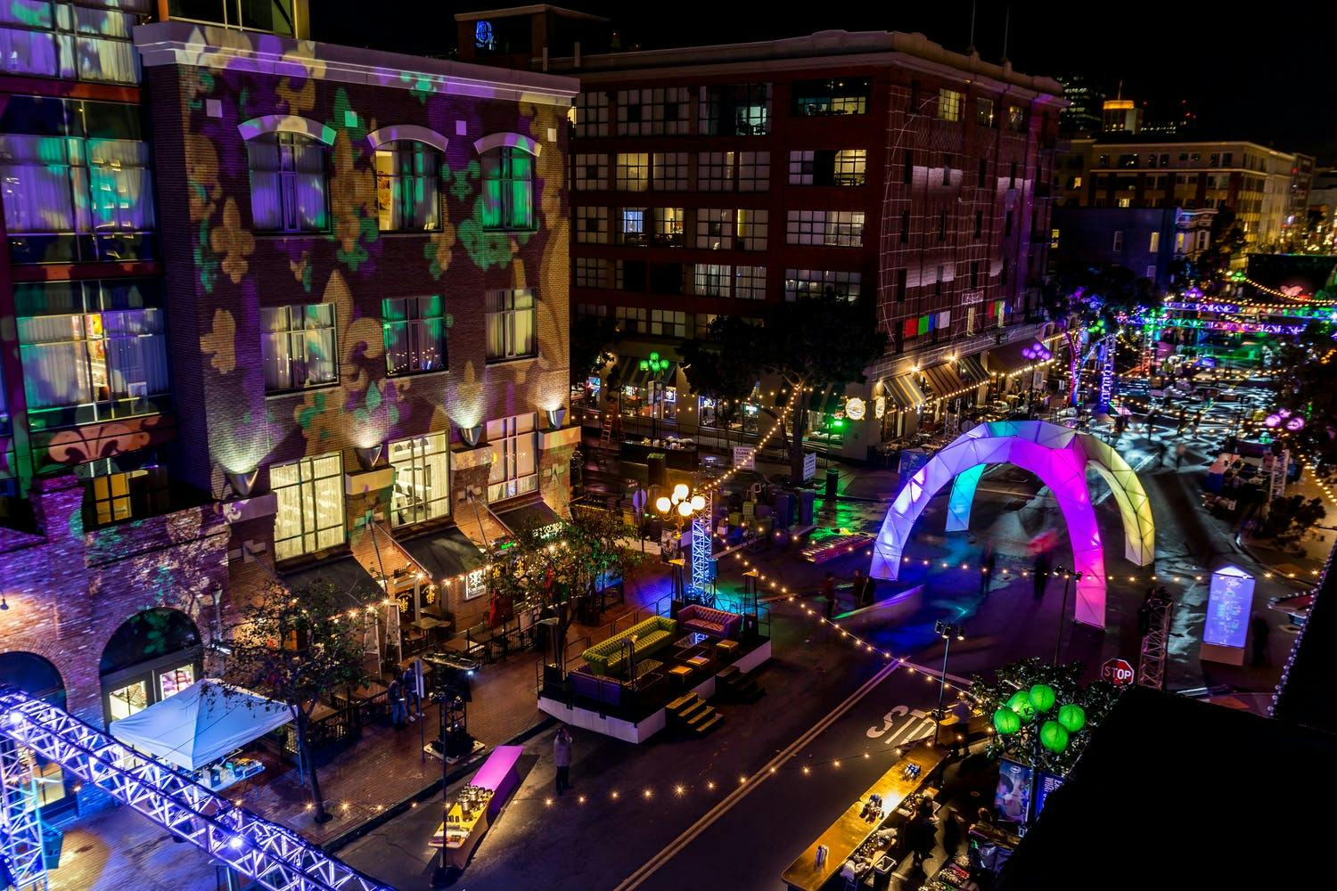 Mardi Gras party held in Gas Lamp Quarter with vibrant purple, pink, gold, and green lighting | PartySlate