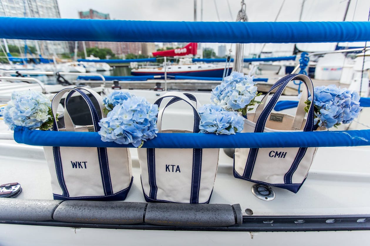 Wedding tote bags filled with blue hydrangeas | PartySlate