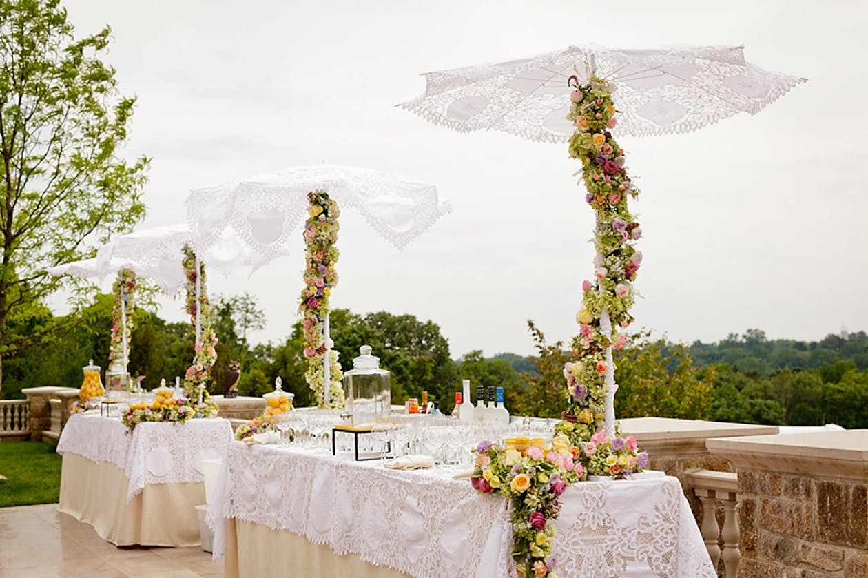 Winding umbrella centerpieces wound with greenery and flowers | PartySlate