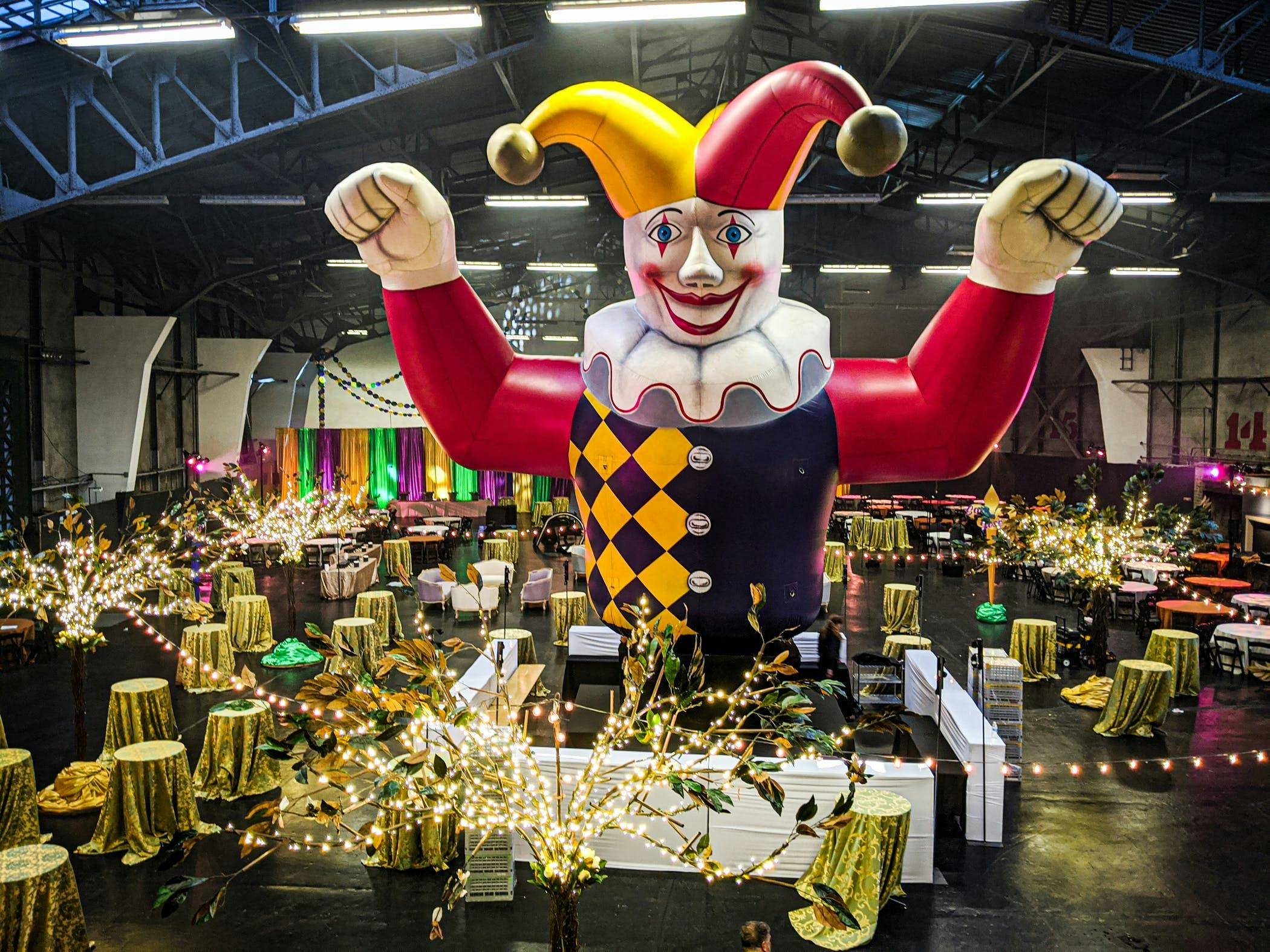 Mardi Gras Themed Holiday Party With Giant Blow Up Jester Doll | PartySlate