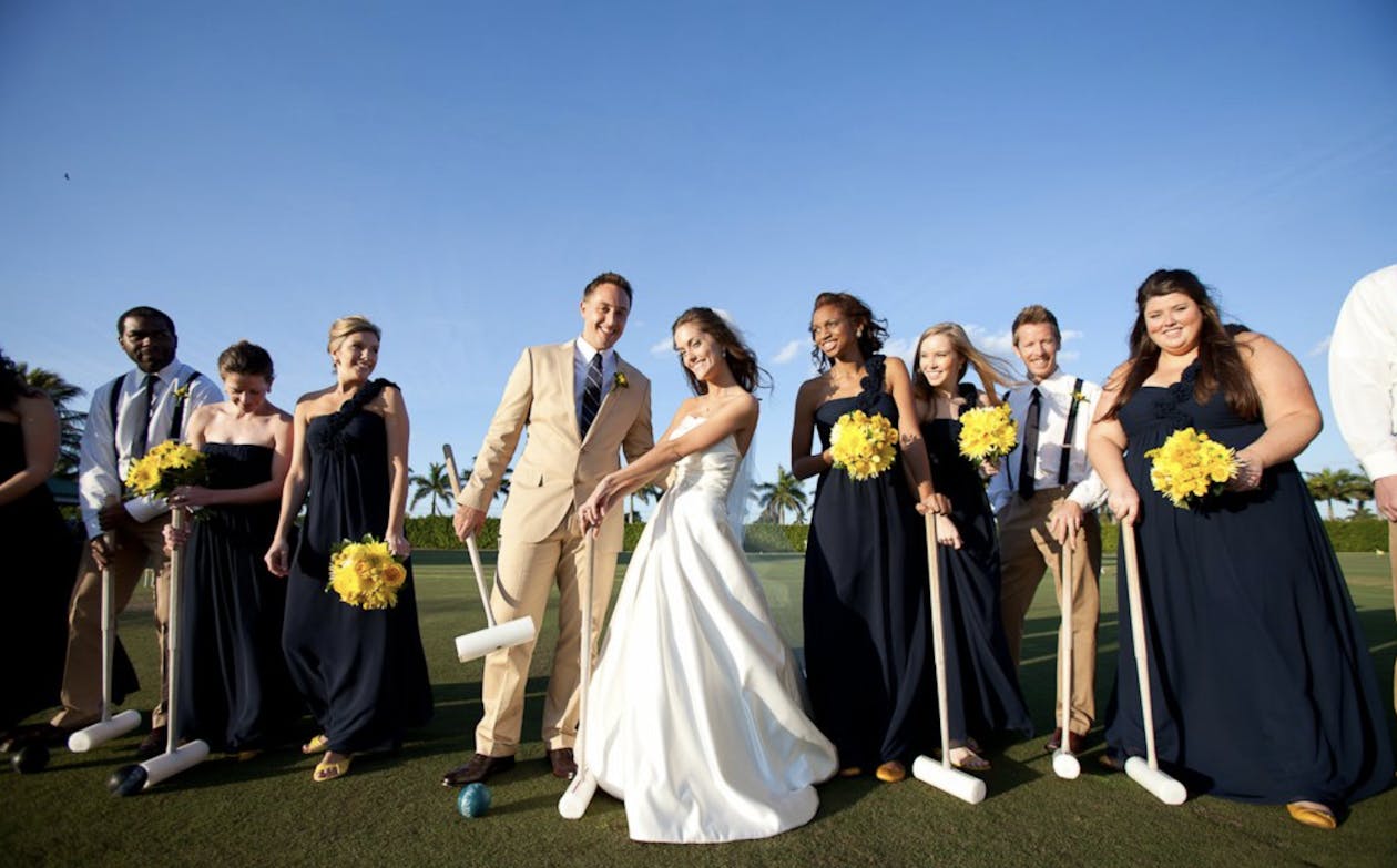 Preppy navy and yellow wedding party playing crochet | PartySlate