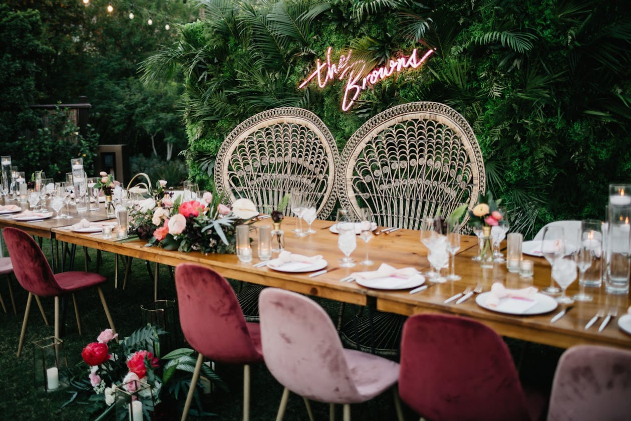 Tropical boho wedding with rattan throne chairs and pink velvet seating | PartySlate