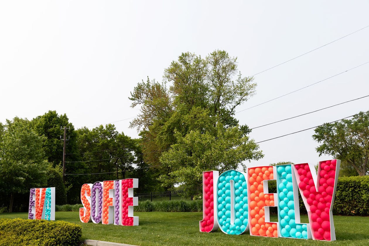 graduation party with graduate's names spelled out in colorful balloons | PartySlate