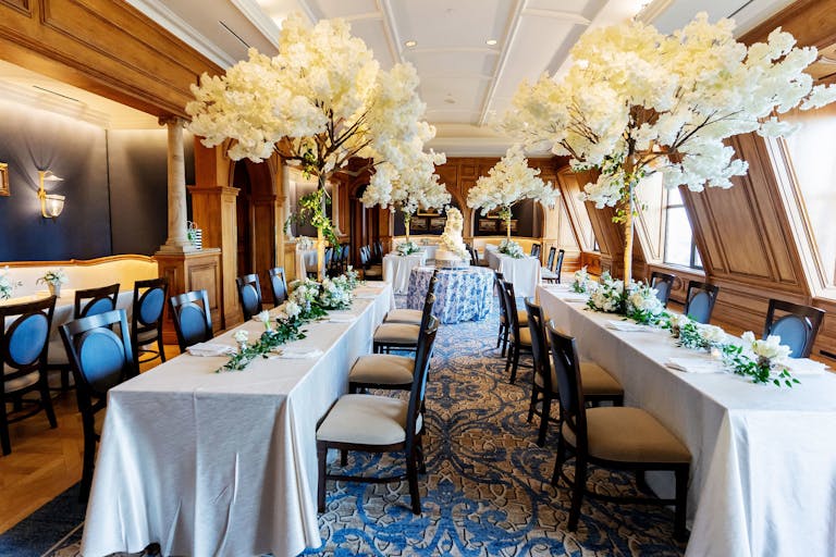 The Crescent Club at The Crescent Court Hotel in Dallas, Texas with White Floral Trees and greenery on tables | PartySlate