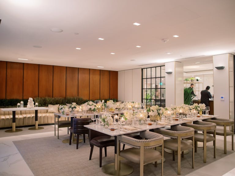 Modern private dining area with wood panels on walls and paned glass doors | PartySlate
