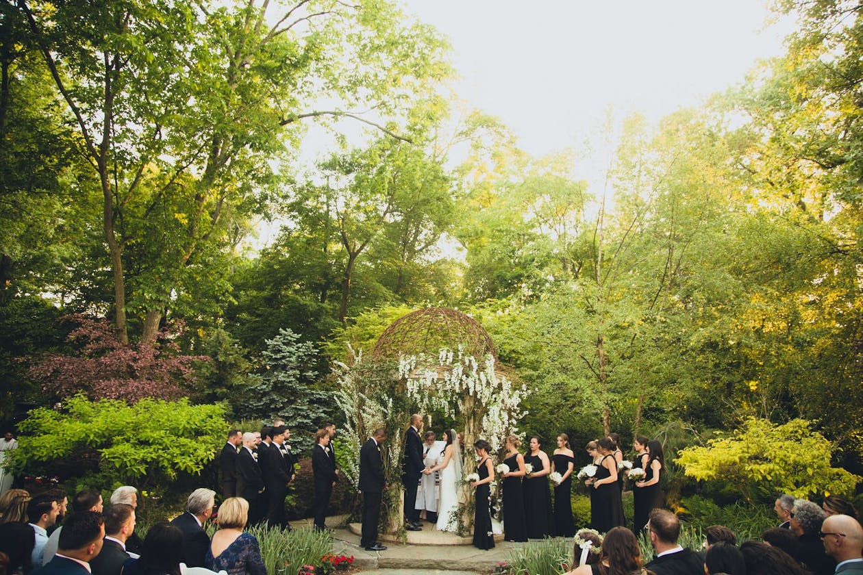 Garden wedding under gazebo | PartySlate