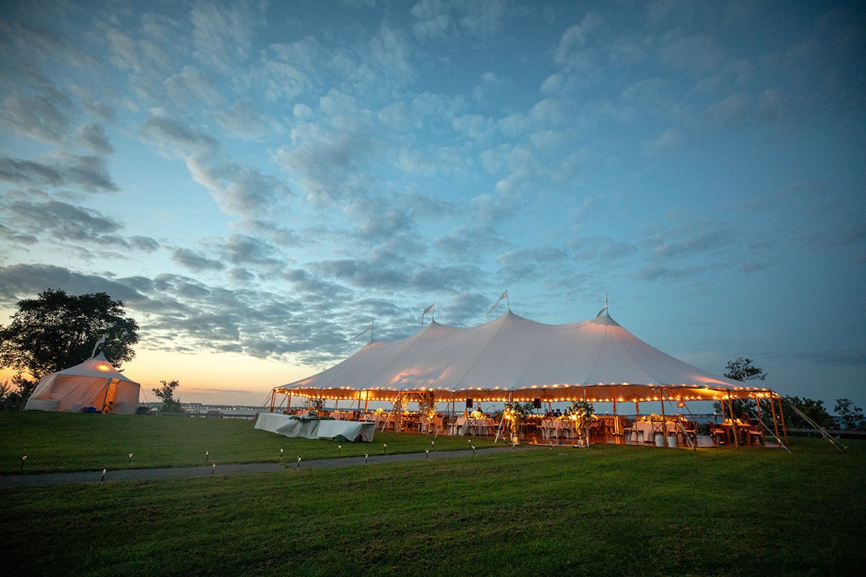 Boston waterfront pole tented wedding at sunset | PartySlate