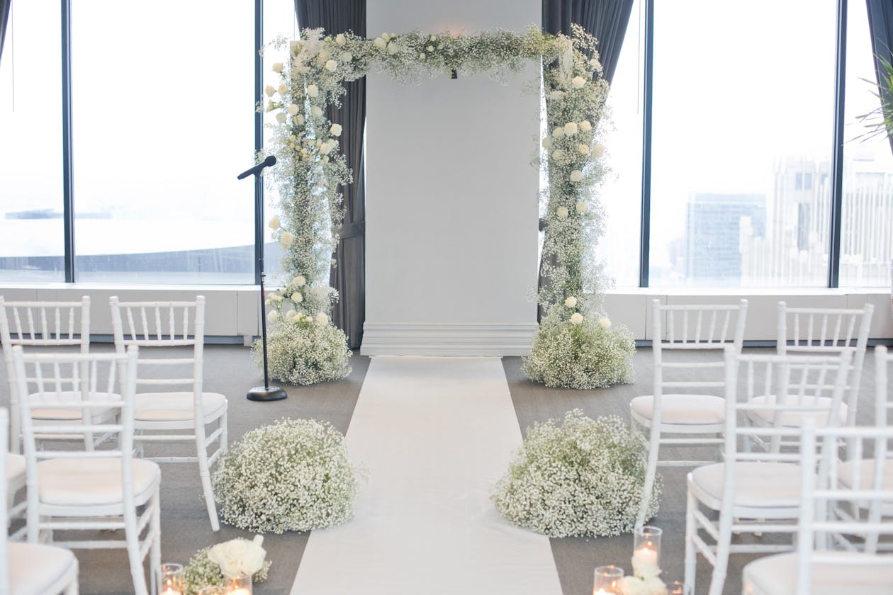 Indoor floral arch covered in babies breath | PartySlate