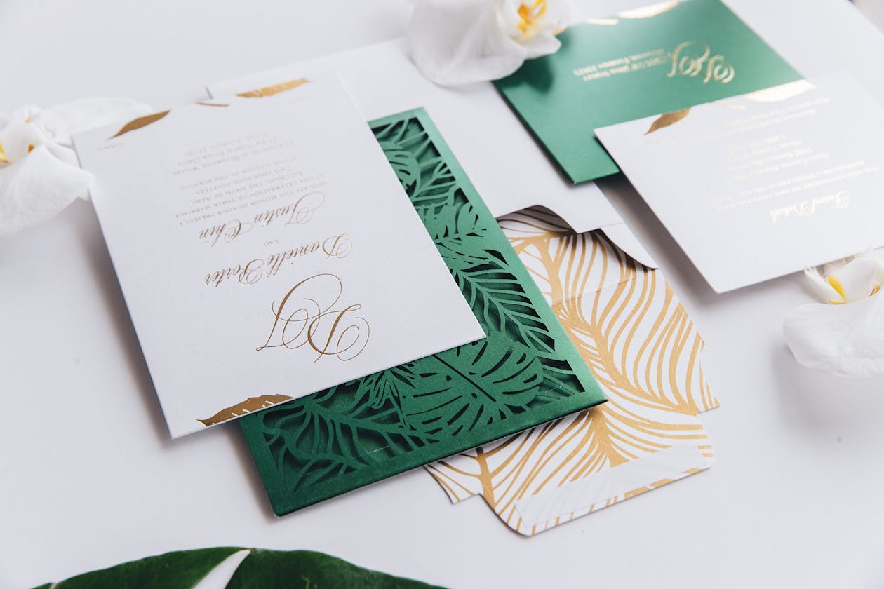 Laser-cut green monstera leaf tropical wedding invitation | PartySlate