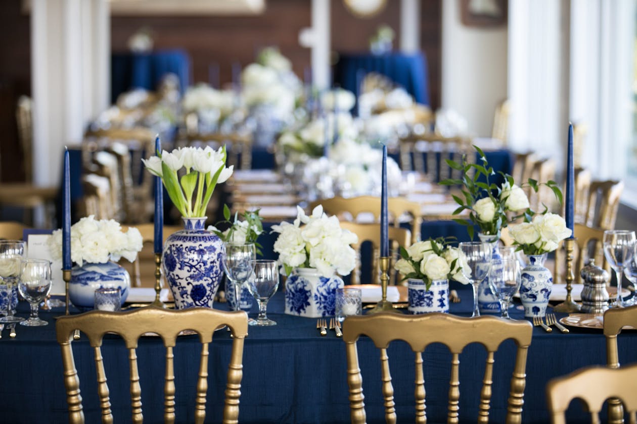 Nautical coastal wedding reception with blue linen and blue and white chinaware | PartySlate