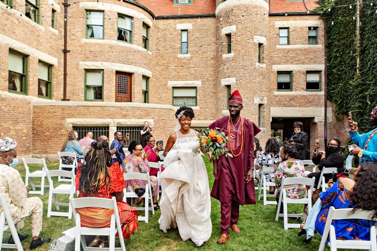 traditional Nigerian wedding at Glesner House with couple in traditional attire walking down the aisle | PartySlate