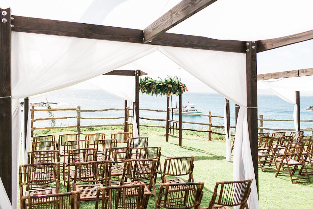 Rustic wedding canopies at beach wedding ceremony | PartySlate
