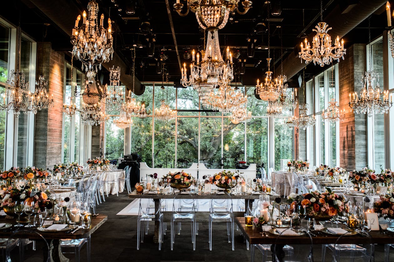 Glassed-in wedding room with glittering chandeliers | PartySlate
