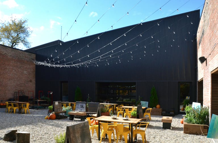 outdoor event space at Guild Row in Chicago with string lights and outdoor furniture | PartySlate