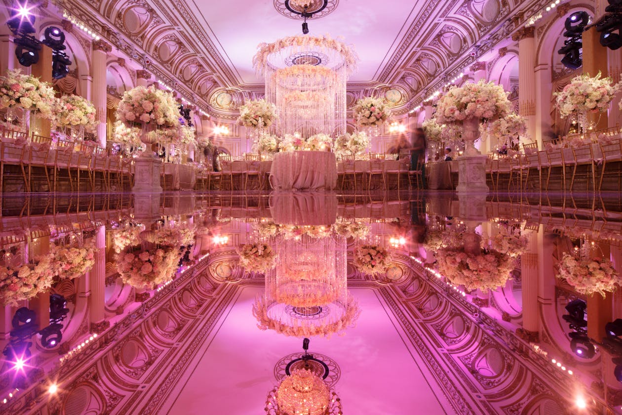 Glamorous pink wedding with mirrored dance floor in ballroom | PartySlate